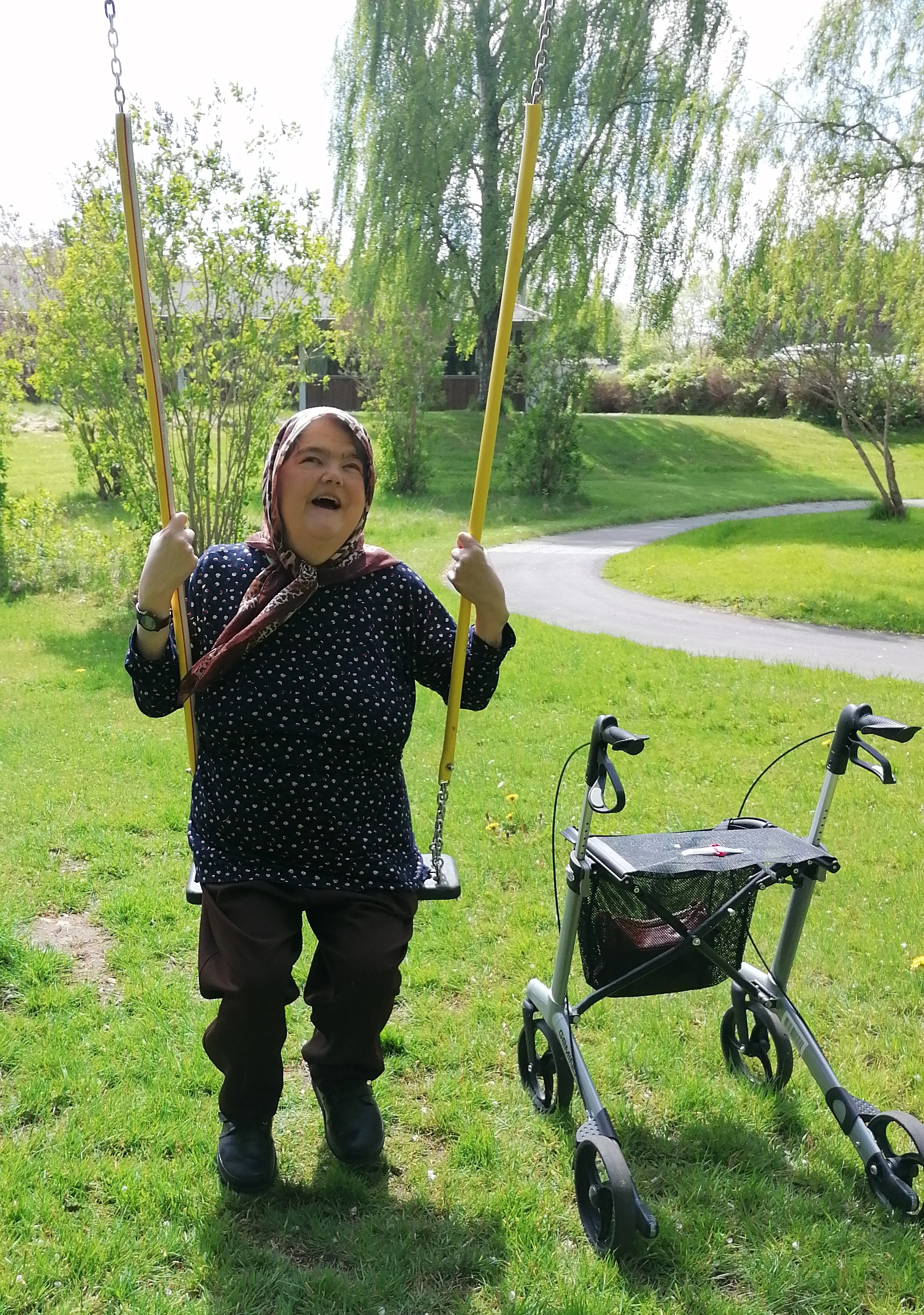 En smilende Nahid på gyngen